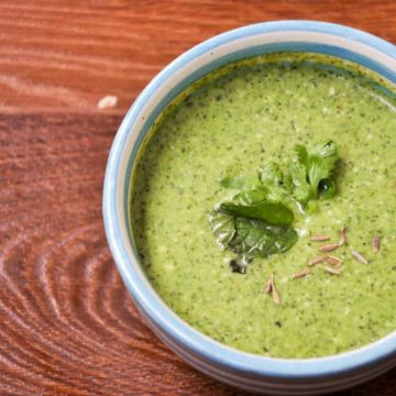 Green chutney served in blue bowl.