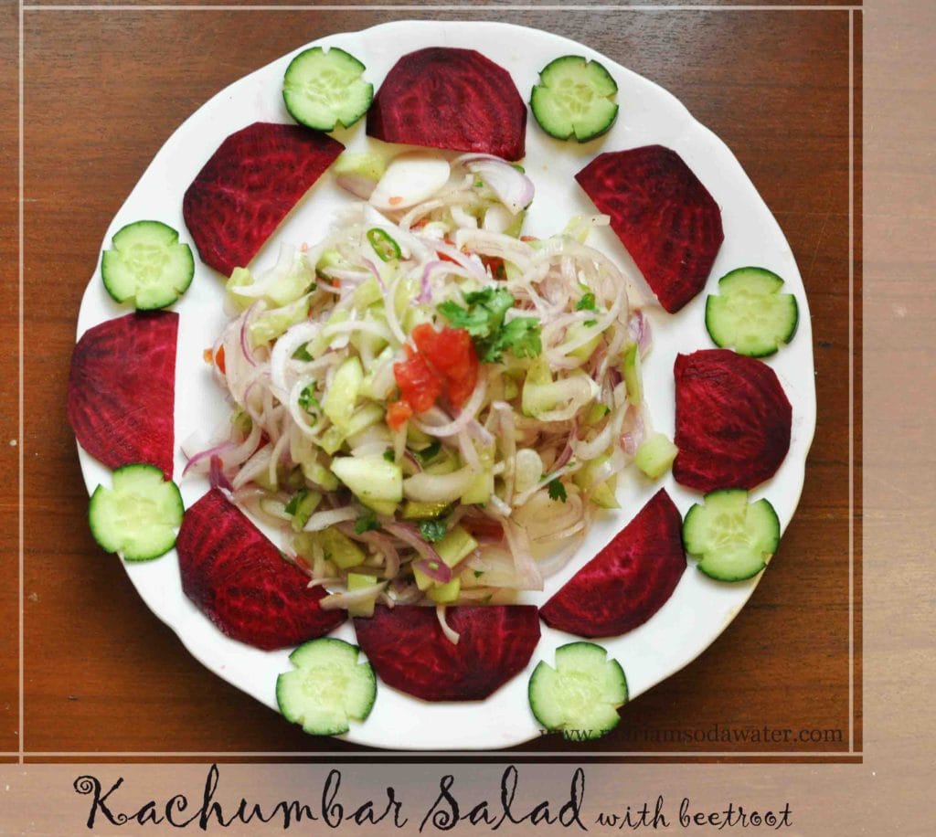 kachumber served in a plate with cucumber flower and beetroot semi circle decorating the plate.