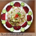 kachumber served in a plate with cucumber flower and beetroot semi circle decorating the plate.