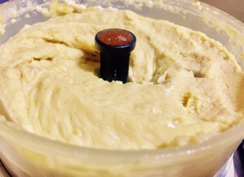Smooth blended hummus in chopper.