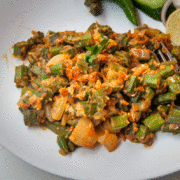 a close up shot of bhindi masala recipe served in a plate.