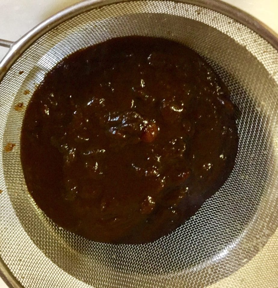 straining tamarind date chutney.