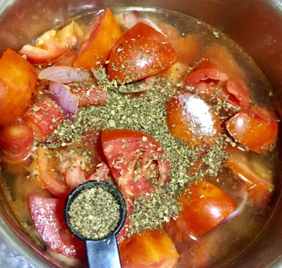adding herbs in tomato soup