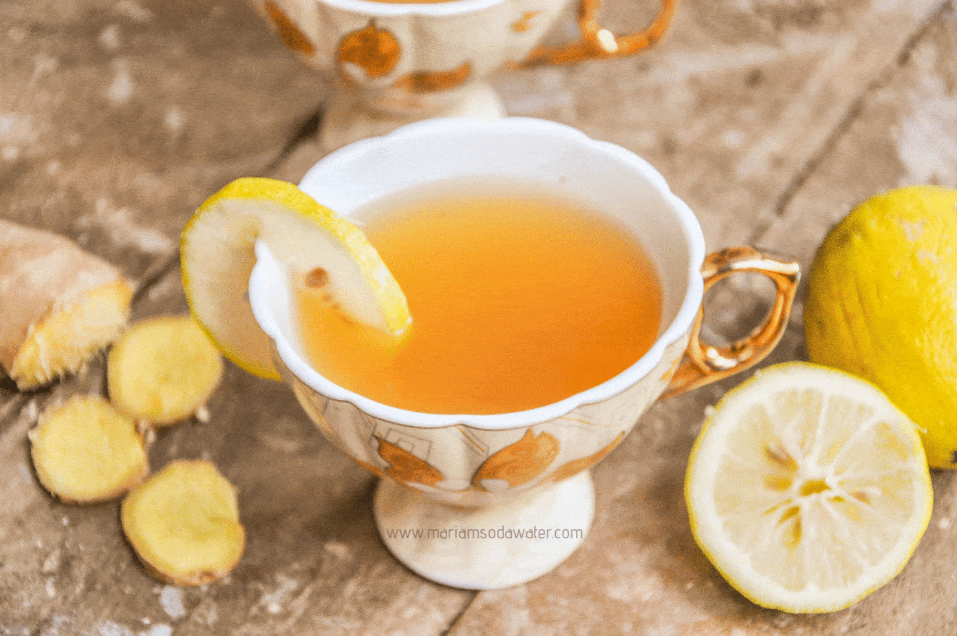 ginger green tea served in a cup with a slice of lemon.