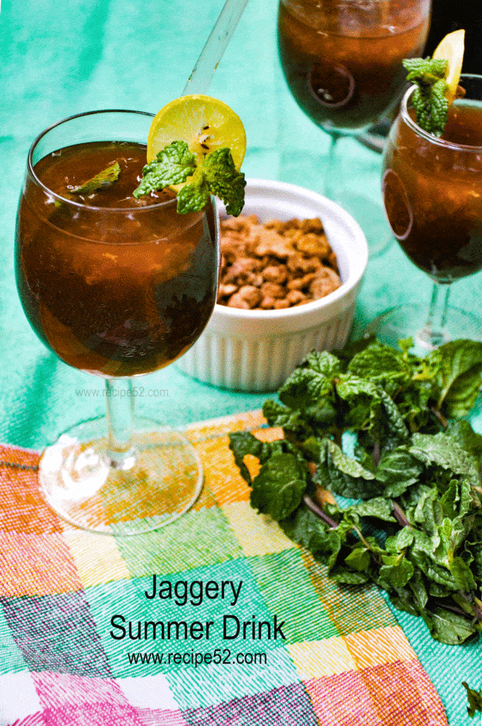 Gud ka sharbat AKA Jaggery juice served in glasses with mint leaves on the side.