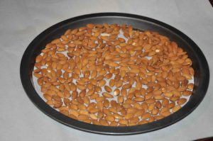 almond in tray for roasting in oven.