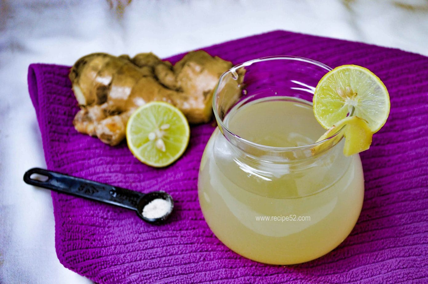 ginger lemonade served with fresh ginger and lemon on the side.