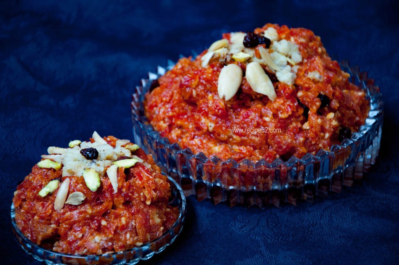 gajar ka halwa served in a dish and garnished with nuts.