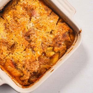 Peach cobbler in a ceramic dish. - 9