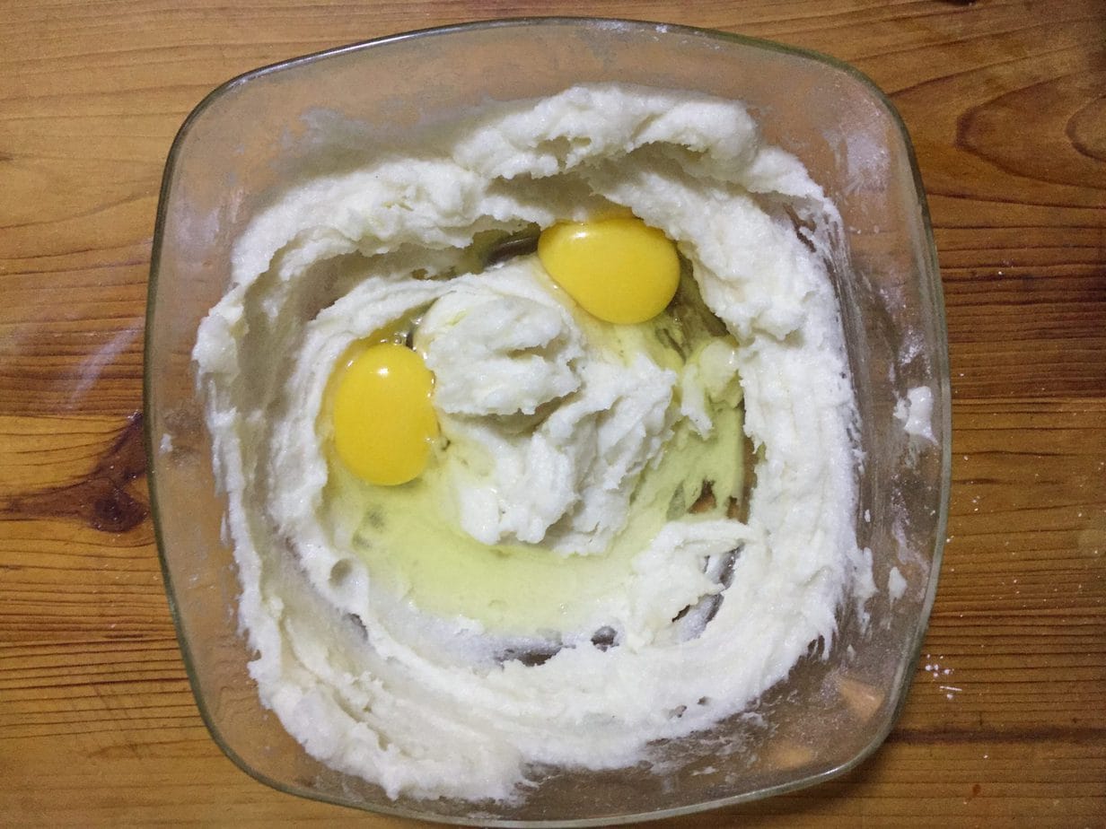 Add eggs to the butter and sugar mixture.