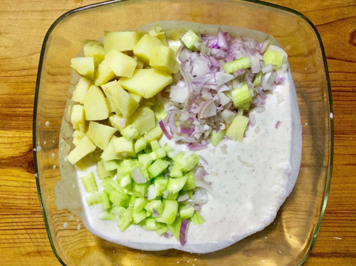 Add veggies to raita.