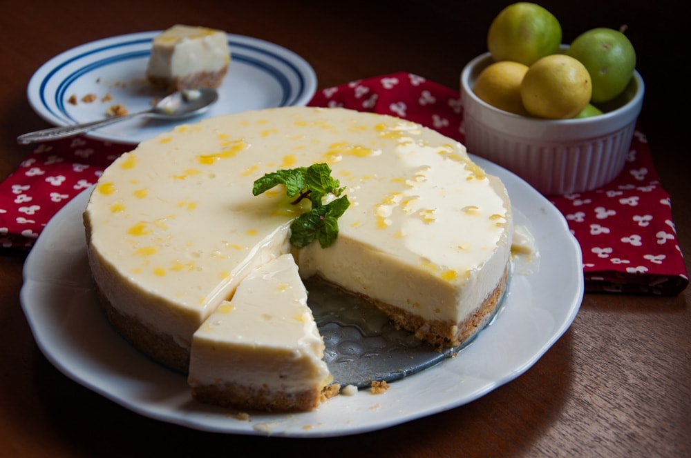 Lemon mousse cake with lemons in the background.