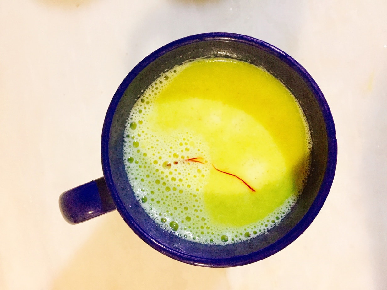 Hareera saffron milk served in a cup.