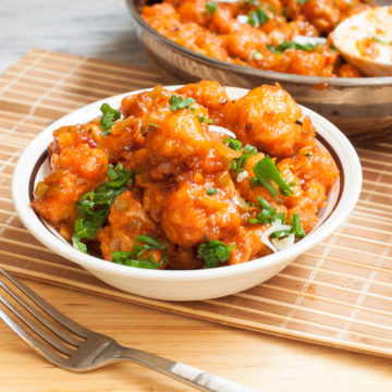 Gobi manchurian served in a bowl with fork.