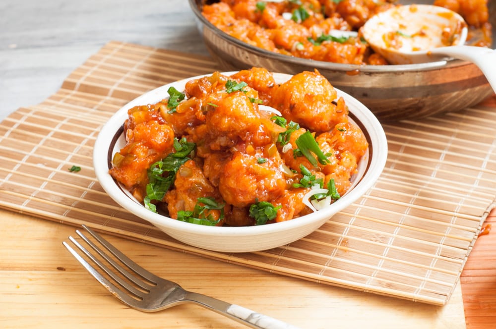 Gobi manchurian served in a bowl with fork.