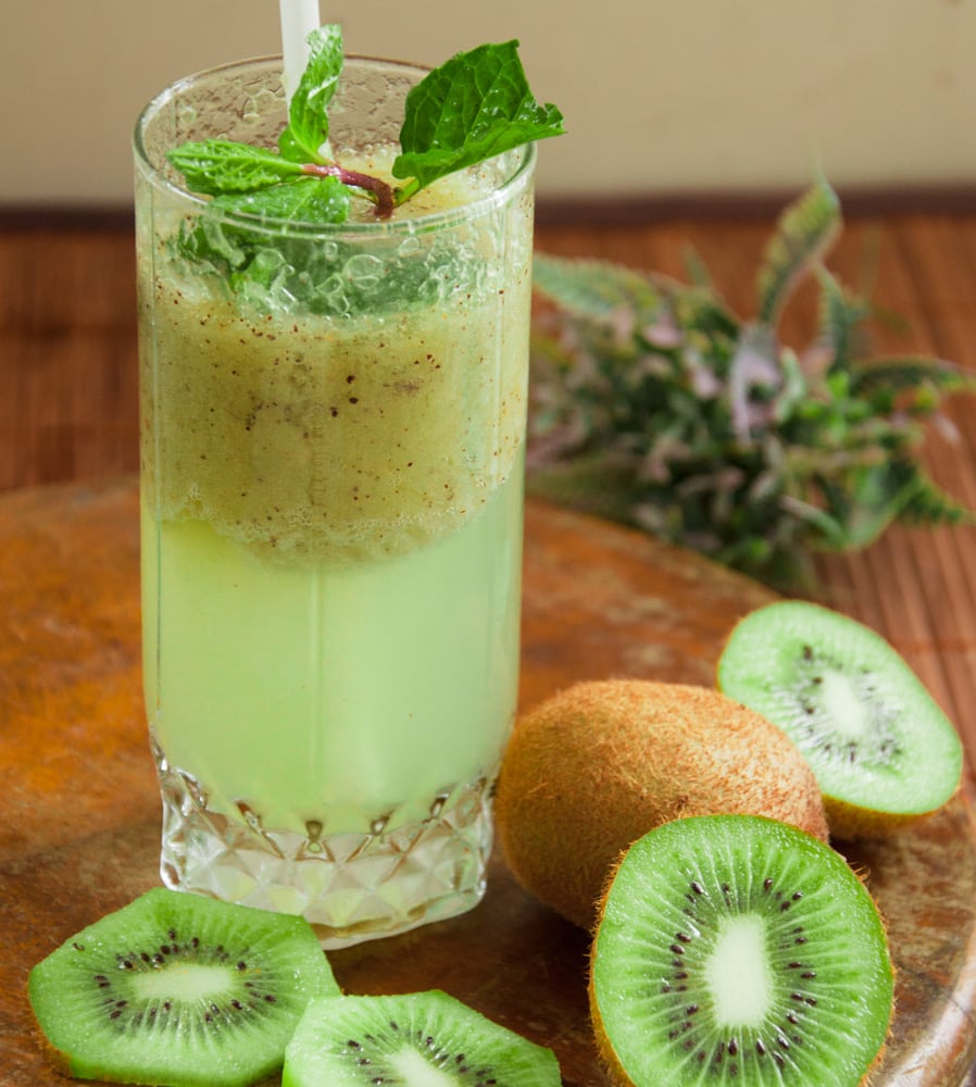 Kiwi juice served in tall glass.