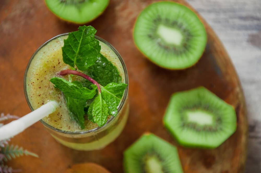 Top view of kiwi juice served in glass.