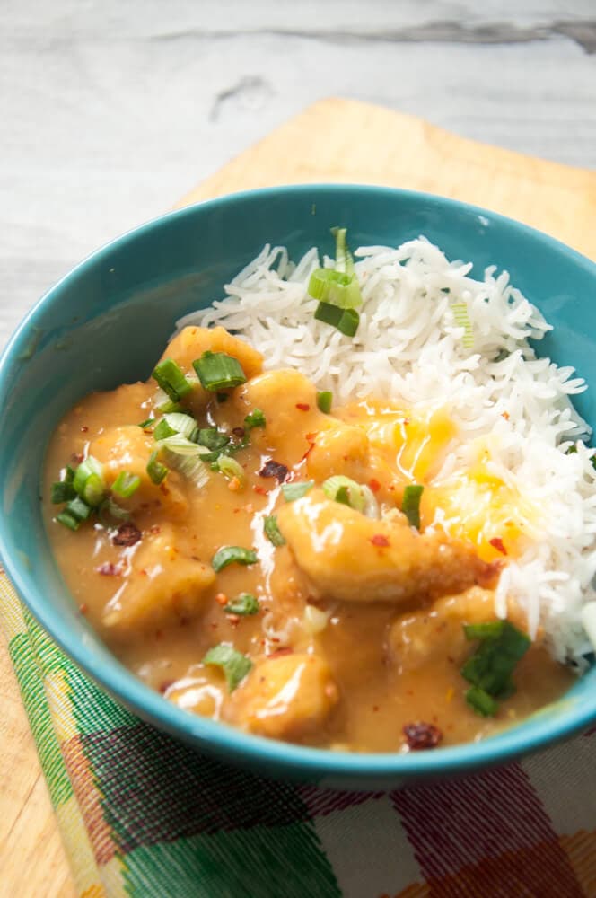 Orange Chicken Served in a bowl with  white rice.