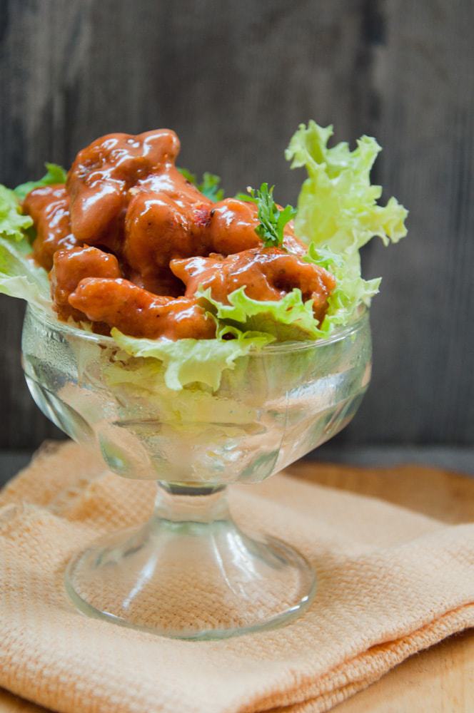 Dynamite Chicken served on a bed of lettuce.