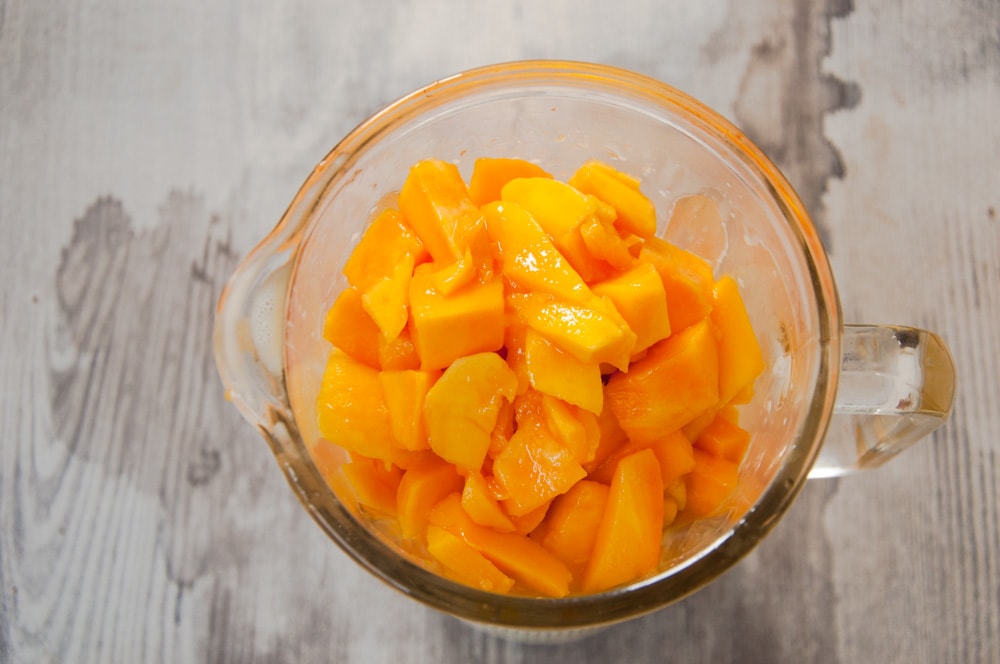 Mango chunks placed in a blender.