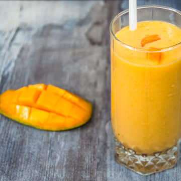 mango milkshake served in glass.