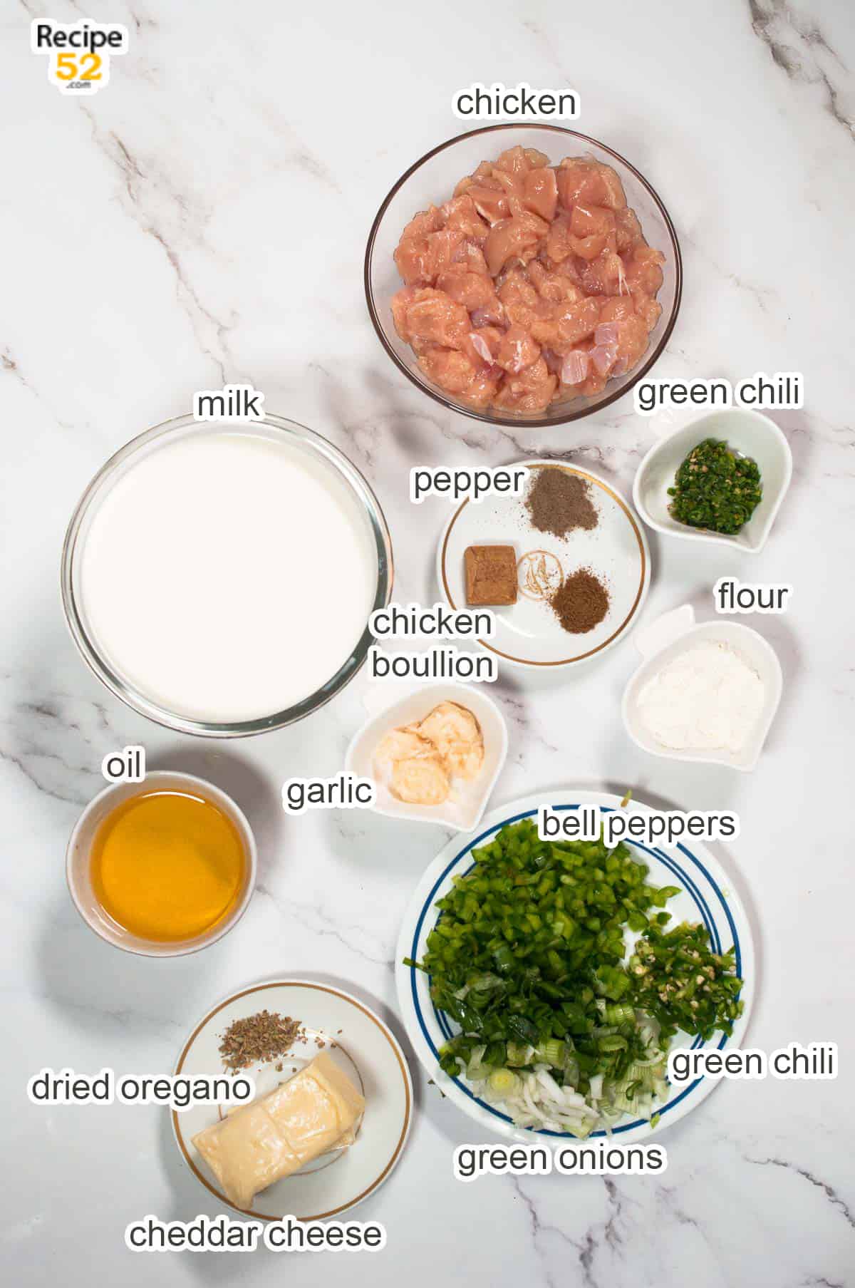 Ingredients of chicken filling on the white marble background.