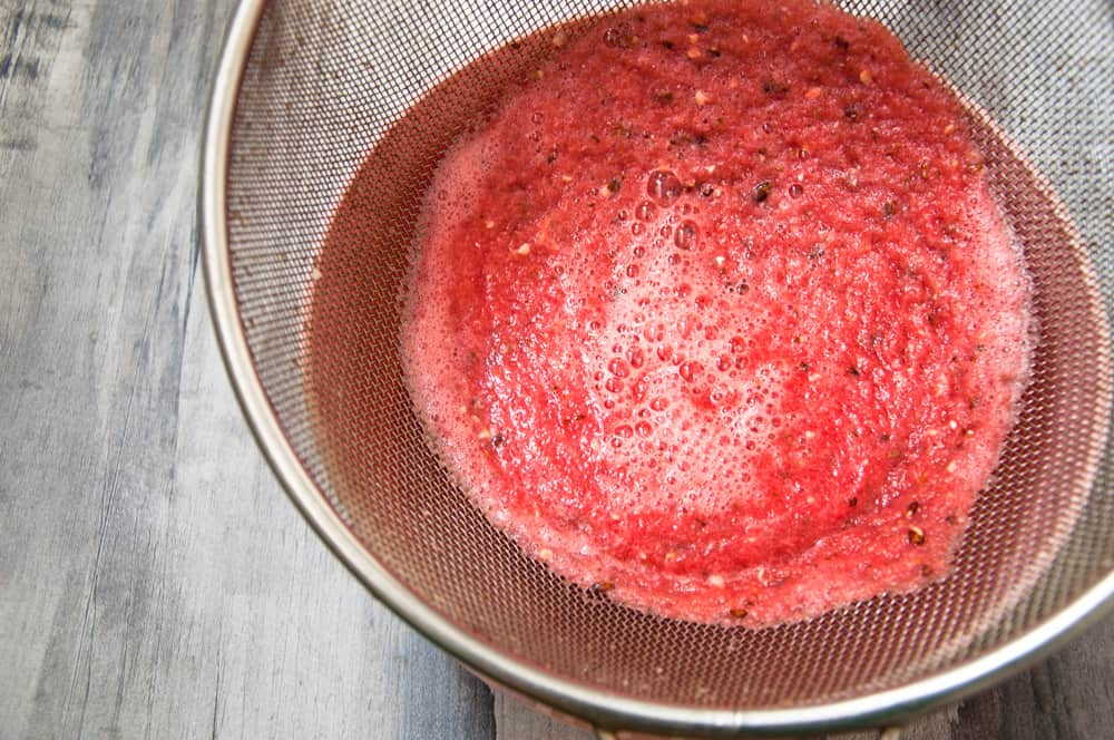 Sieving juice through a coarse strainer.