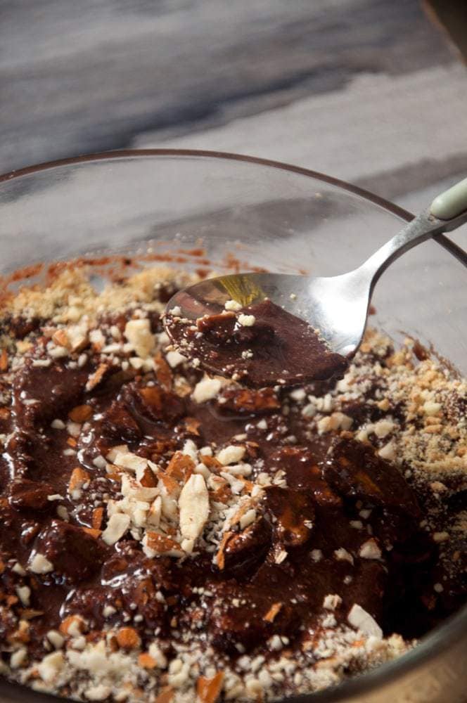 A spoon filled with chocolate biscuit pudding, close up shot.