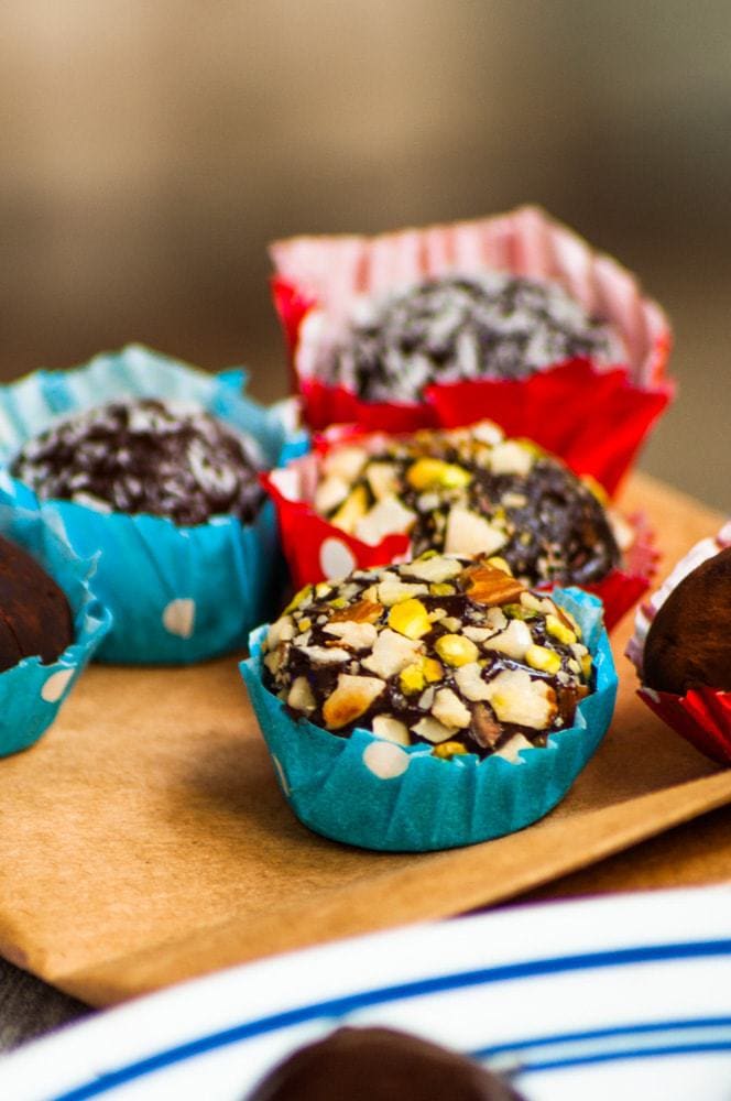 Different variations of Brigadeiro Chocolate truffles served in blue and red bon bon cup.