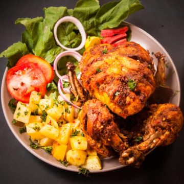 Chicken Charga Served in a plate with sides.