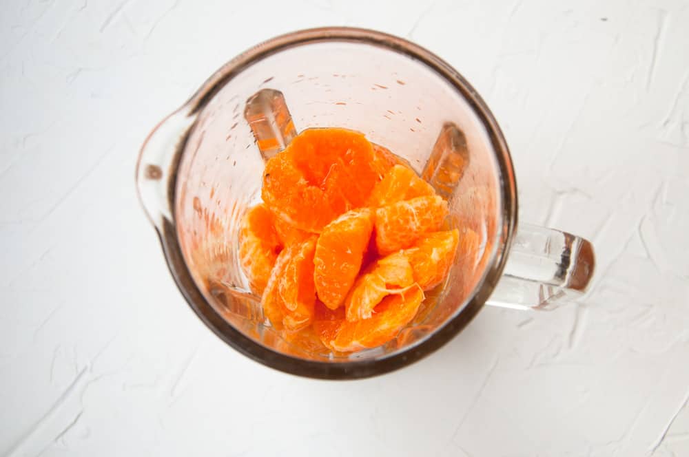 Orange chunks in a blender.