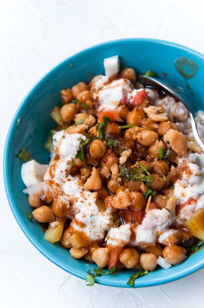 Channa chaat assembles in a blue kea bowl.