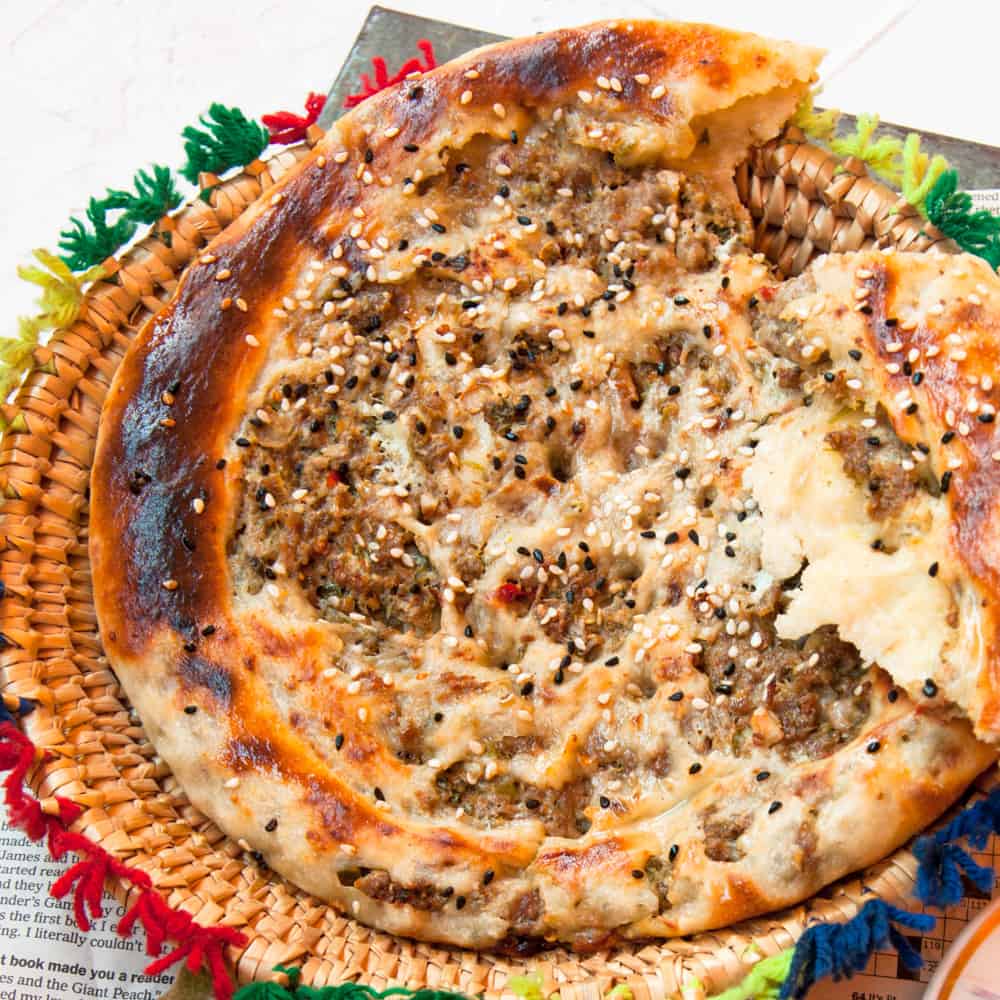 keema naan with an un eaten bite on the side.