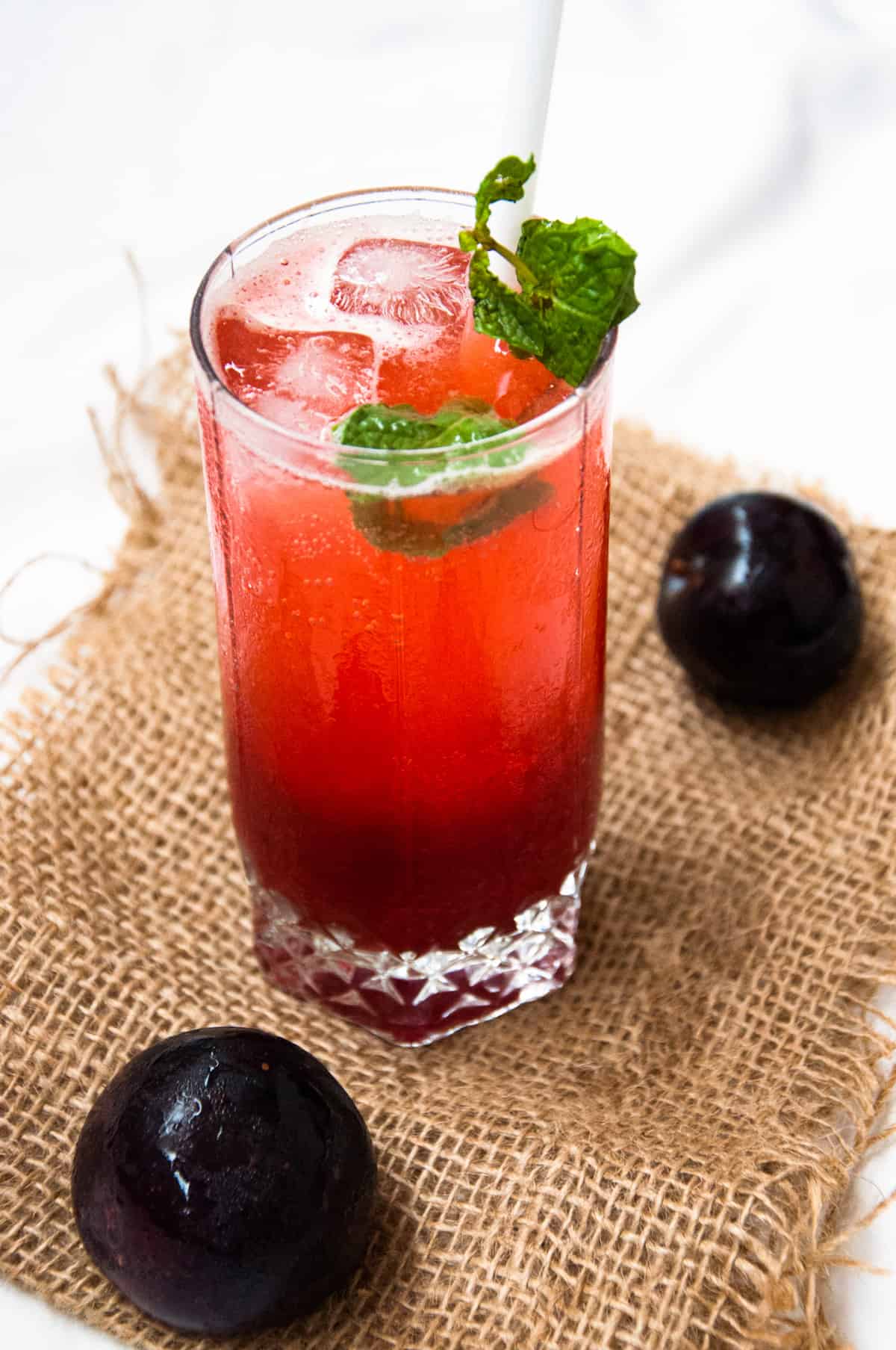 Plum lemon soda served in a glass.