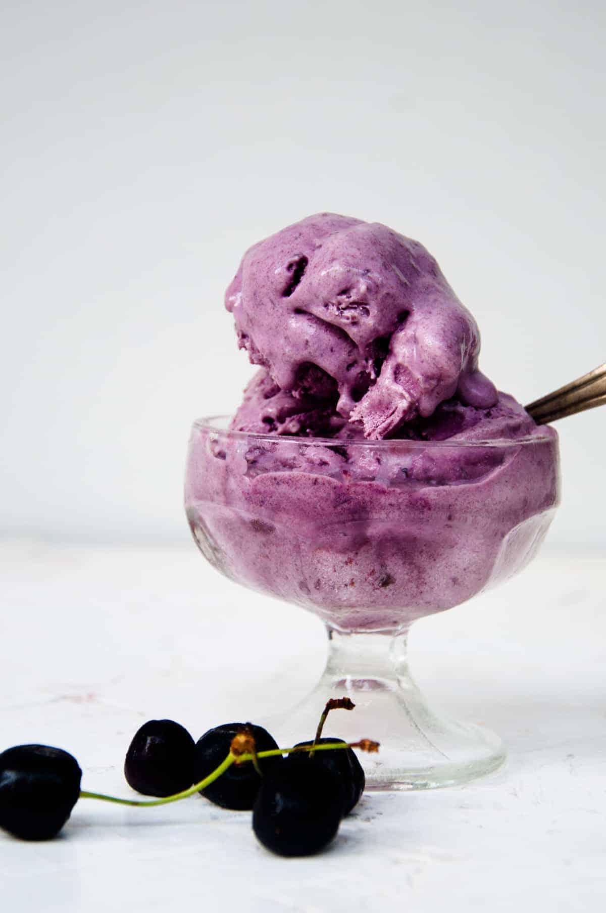 Cherry ice cream scoops served  in  a cup.