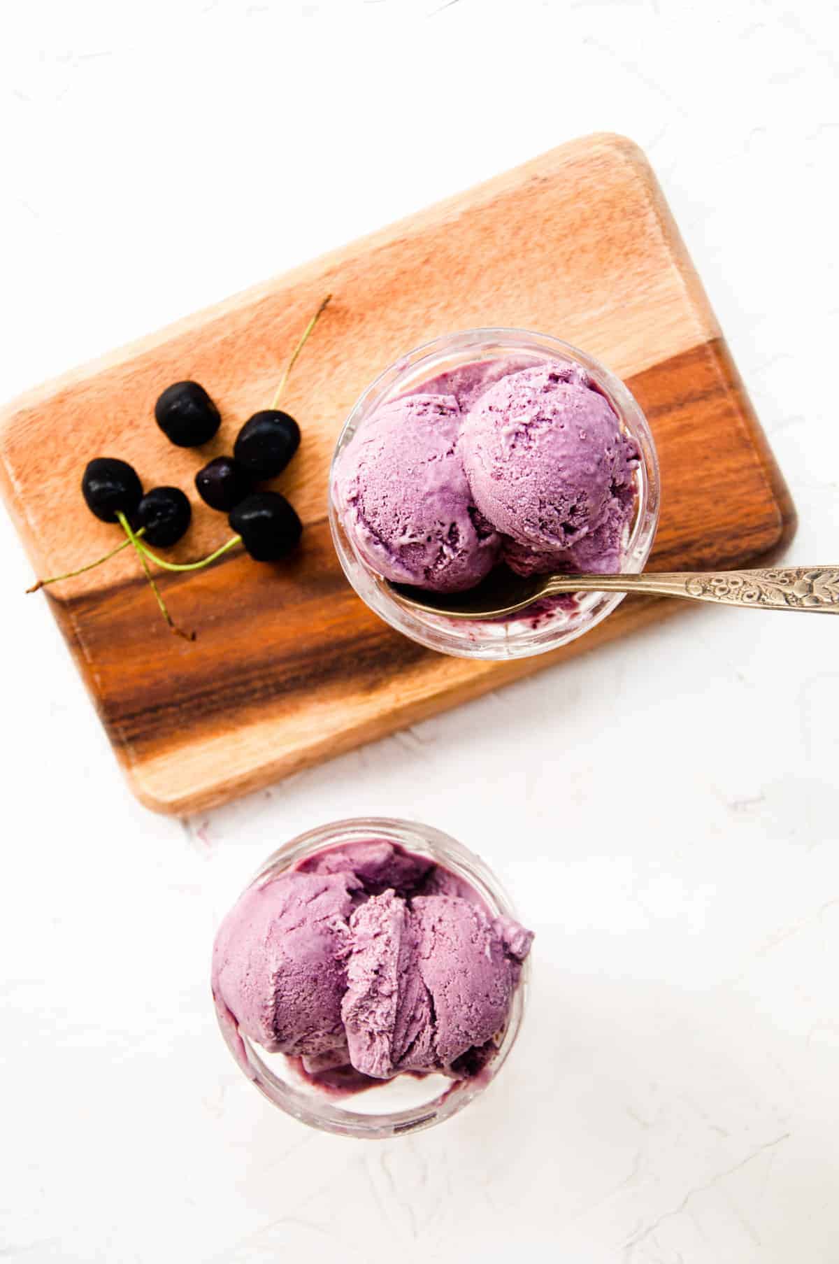 Cherry ice cream served in two ice cream cups.