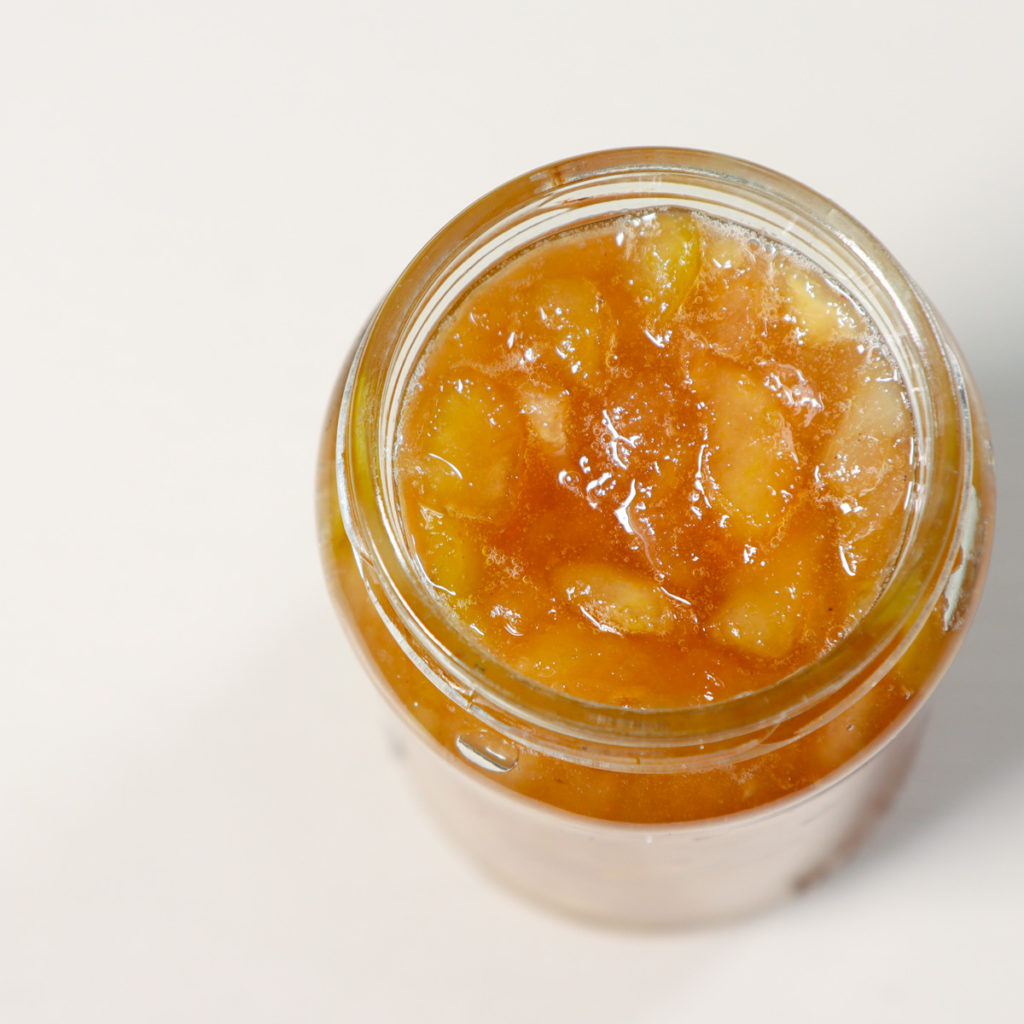 A close up of pear jam in a jar.