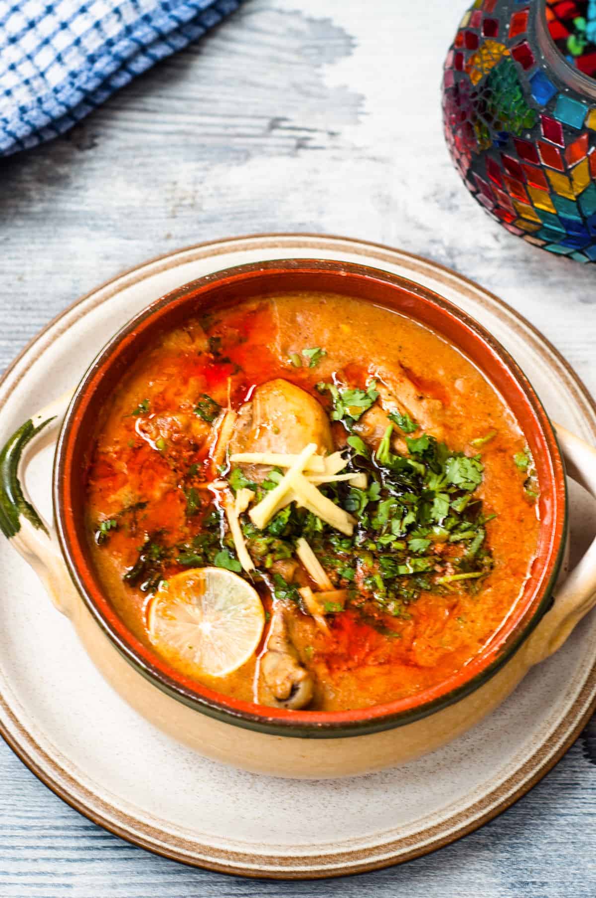 Warm Nihari served in large clay bowl.