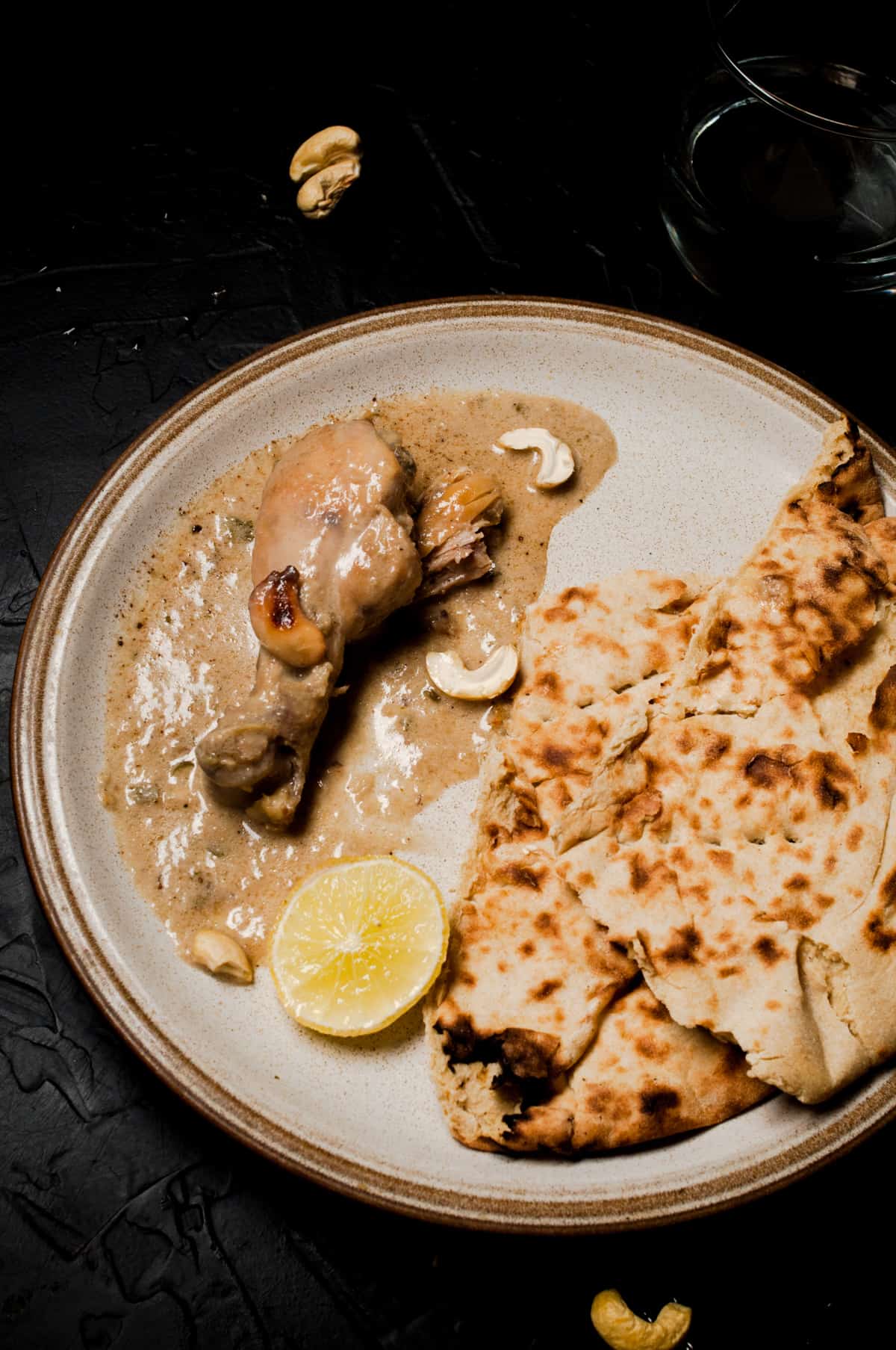 white korma served with cashew and naan for individual serving.