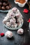 Date coconut energy balls stacked in triangular mound.