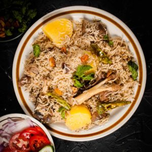 Mutton yakhni pulao served in a plate.