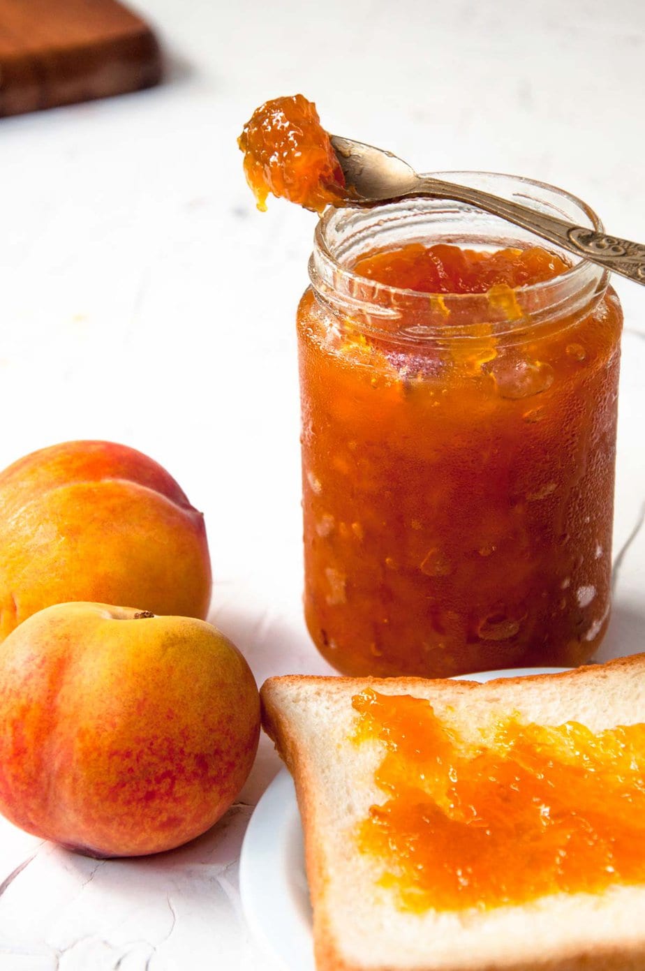 A shot of jam jar, toast and peaches.