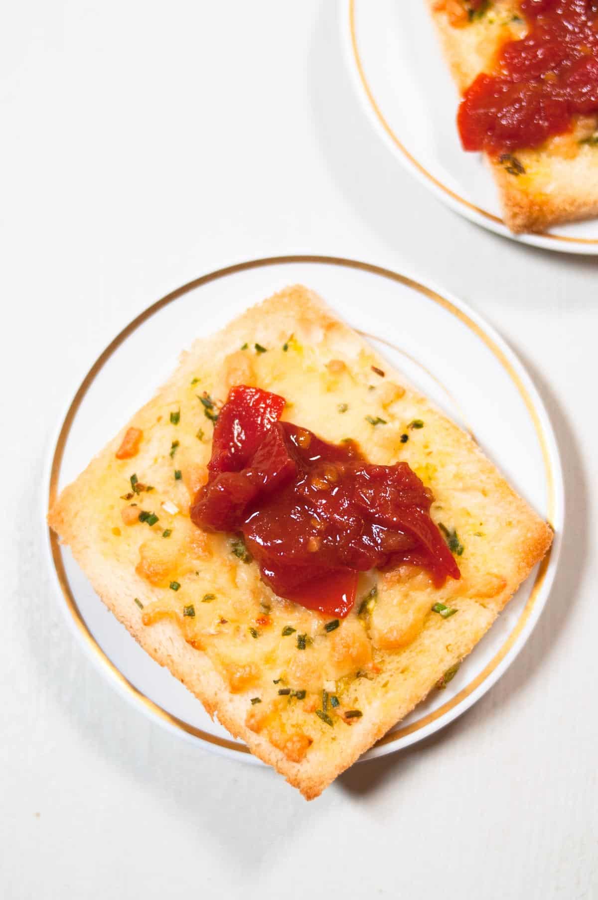 Tomato jam on a slice of cheese toast.