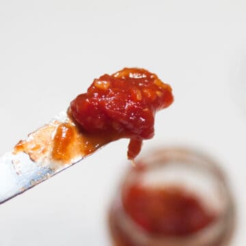 Tomato jam on a butter knife