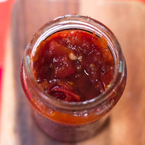 A close up shot of tomato jam in a jar.