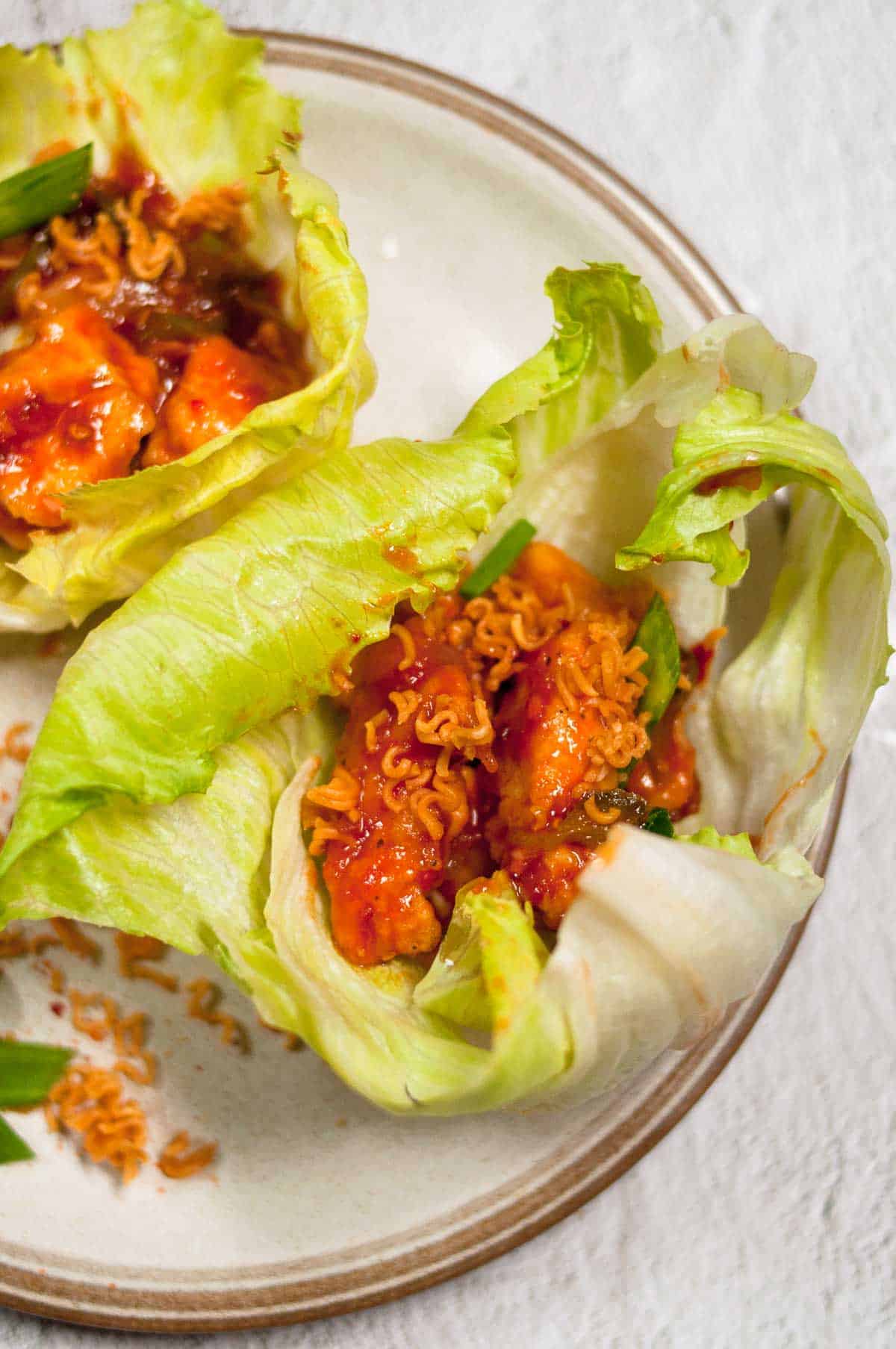 A close up shot lettuce wrap in the plate.
