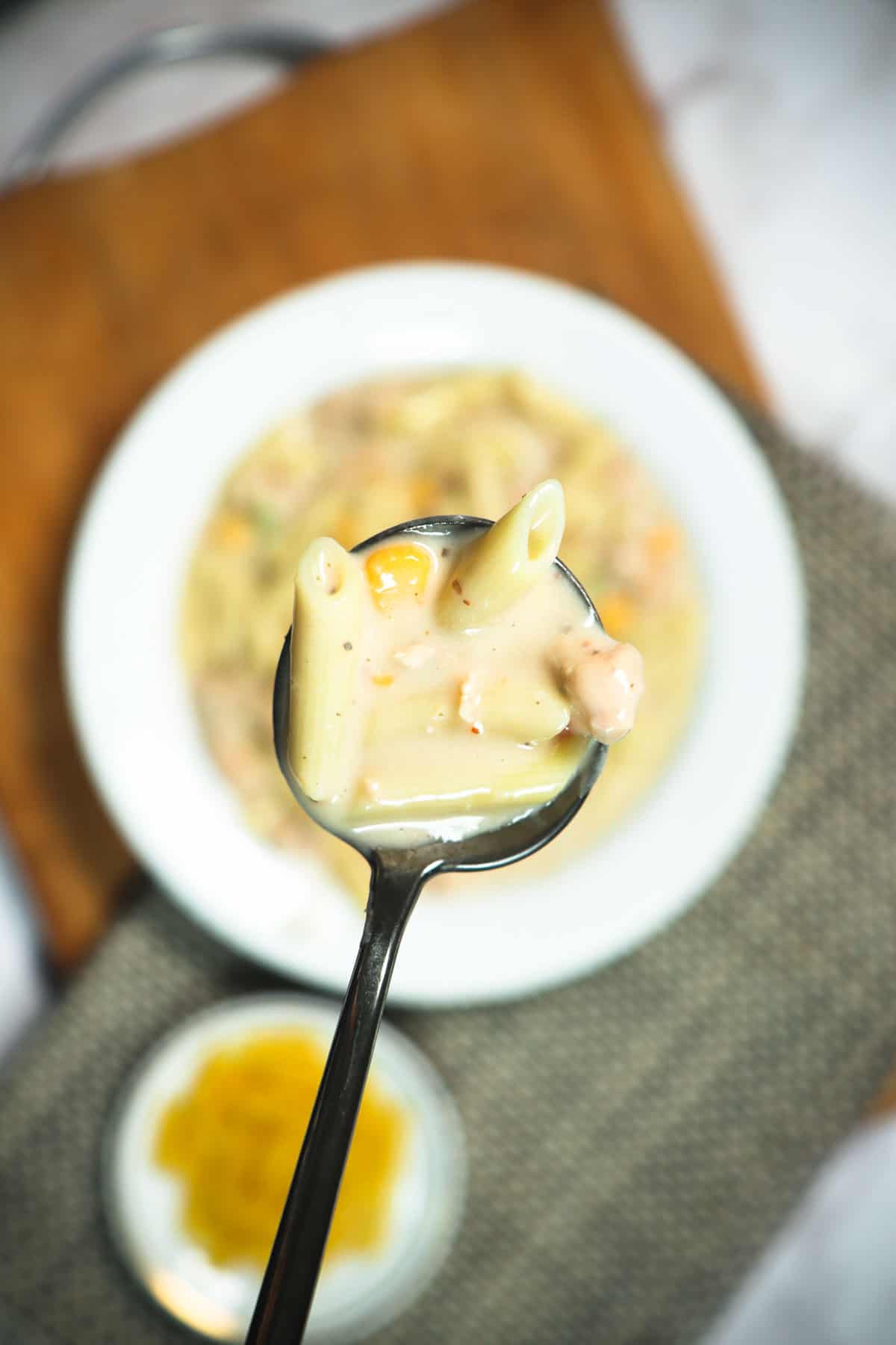 A close shot of pasta in a spoon.