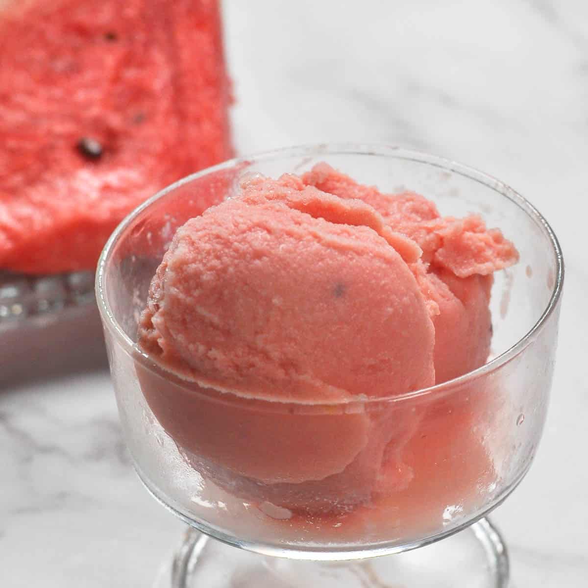 Watermelon Ice cream scooped in a glass container.