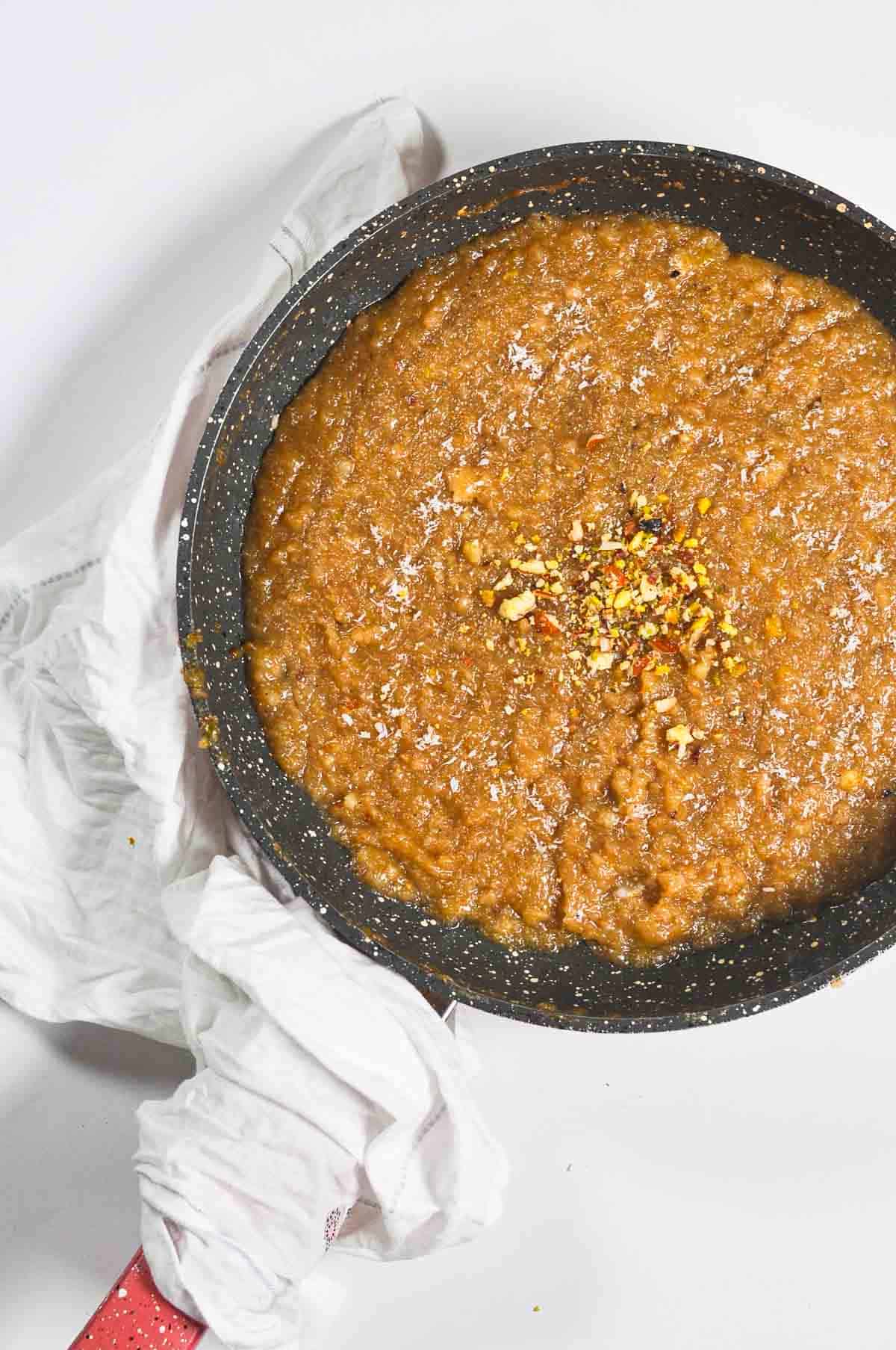 Lachko halwa in a pan, garanished with crushed nuts.