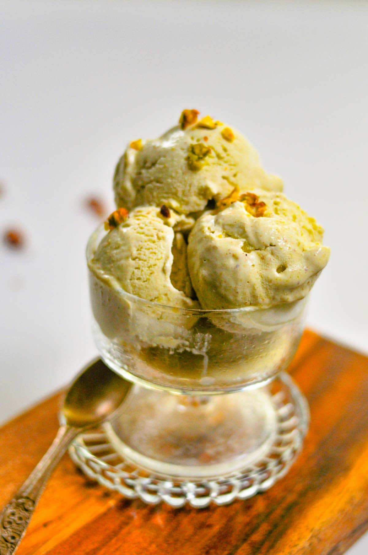 Pistachio ice cream served in a glass ice cream bowl.